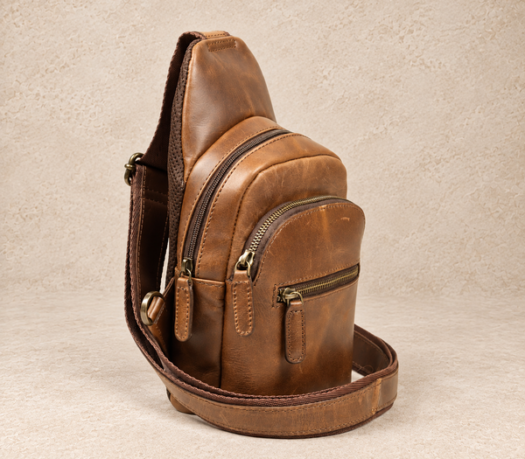 Warm cognac distressed-leather body bag AIL-BB-0003, shown from a front three-quarter angle