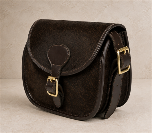 Dark Brown Hair-on-Hide Hunting Bag AIL-HP-0017 front three-quarter view on warm limestone studio background